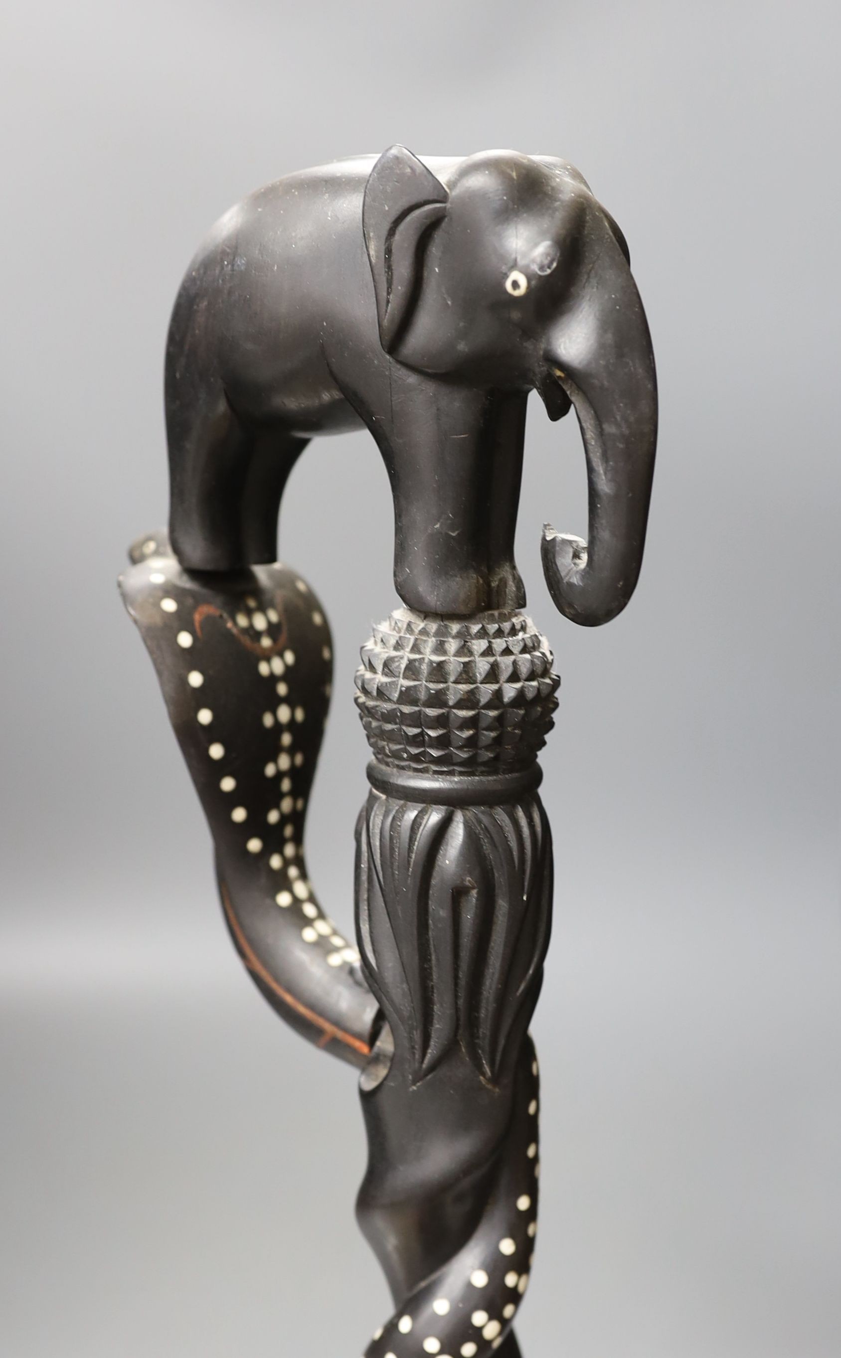 A late 19th/early 20th century Ceylonese carved ebony ‘elephant’ walking stick, 90cm